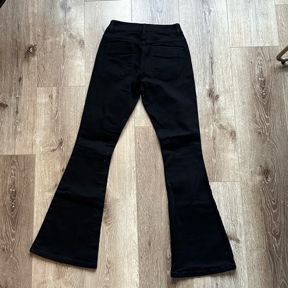 ASOS DESIGN Petite Bell Flare Jeans in Clean Black with Pressed Crease - Picture 6 of 7
